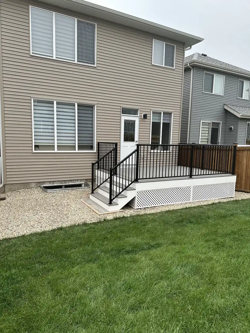Backyard composite deck with aluminum railing, stairs and lattice skirting, Edmonton — TrueBlue Builders Ltd